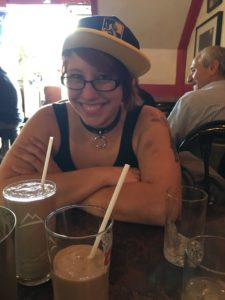 my adorable friend Bex smiling and drinking a milkshake