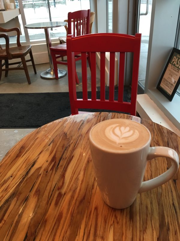 a chair, a table, and a latte