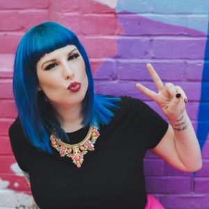 blogger Kat Williams doing a kiss face and making a peace sign